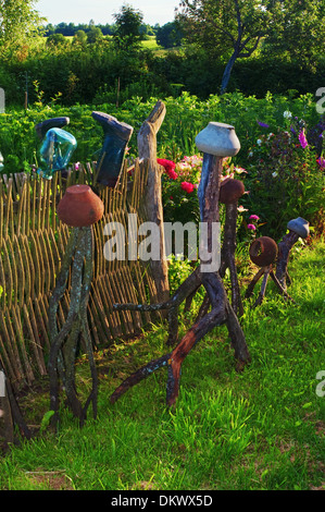 Fence from wooden rods and rural ware hanging on it - 1. Stock Photo