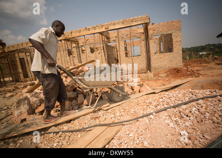 Construction workers build a new warehouse on the outskirts of Kampala, Uganda, East Africa. Stock Photo