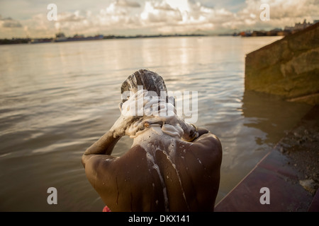 Man bathing along the Hooghly River - Calcutta (Kolkata), India. Stock Photo