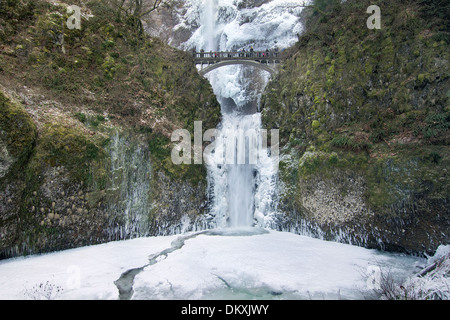 Bridge with People Faces Blurred Over Multnomah Falls at Columbia River Gorge Oregon Frozen in Winter Season Stock Photo