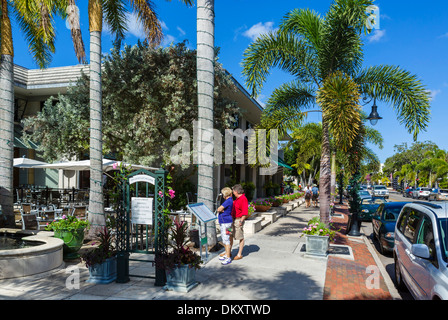 Middle aged couple looking at a menu outside a restaurant on Third Street South in downtown Naples, Gulf Coast, Florida, USA Stock Photo