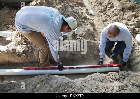 Poly Vinyl Chloride (PVC) Pipes being installed for rainwater harvesting system at new home construction. Los Angeles, Californi Stock Photo