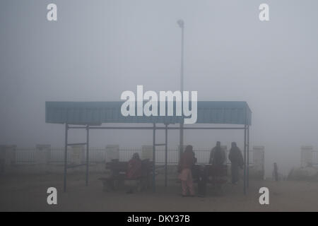 Haryana, India. 10th Dec, 2013. Local people wait for trains on a foggy day in a village near the city of Jind, Haryana, India, Dec. 10, 2013. Heavy fog cloaked many places in north India's states of Haryana and Punjab, with visibility less then 200 meters in some areas, affecting public transportation and local people's life. Credit:  Zheng Huansong/Xinhua/Alamy Live News Stock Photo