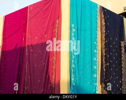 Colourful indian saris hanging out to dry outside a rural indian home. Andhra Pradesh, India Stock Photo