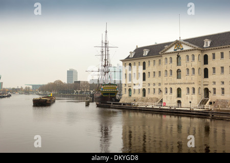 AMSTERDAM THE NATIONAL MARITIME MUSEUM OR HET SCHEEPVAART MUSEUM WITH A REPLICA OF AMSTERDAM A DUTCH EAST INDIES SAILING SHIP Stock Photo