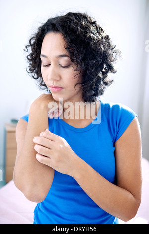 ITCHING IN A WOMAN Stock Photo
