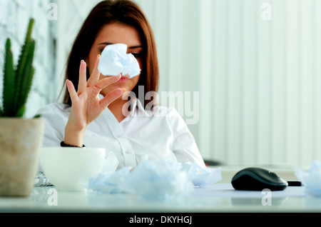 Young frustrated businesswoman throwing paper on table Stock Photo