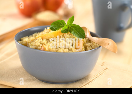 Quinoa porridge with apple and cinnamon, which is a traditional Peruvian breakfast, garnished with mint leaf Stock Photo