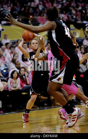 Feb. 14, 2010 - Pittsburgh, PA, U.S - 14 February 2010: University of Louisville freshman guard Shelby Harper (1) is ready to make a pass to University of Louisville junior center Keshia Hines (45) as University of Pittsburgh junior guard Brittaney Thomas (12) moves in between them to try and make a block in the second half of NCAA women's Big East basketball action at the Petersen Stock Photo