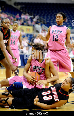 Feb. 14, 2010 - Pittsburgh, PA, U.S - 14 February 2010: University of Pittsburgh junior guard Shayla Scott (25) gets taken down by University of Louisville sophomore forward Monique Reid (33) as they were going for a rebound in the second half of NCAA women's Big East basketball action at the Petersen Events Center in Pittsburgh, PA...The Pitt Panthers players are wearing pink unif Stock Photo