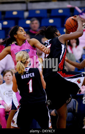 Feb. 14, 2010 - Pittsburgh, PA, U.S - 14 February 2010: Both University of Pittsburgh junior guard Shayla Scott (25) and University of Louisville freshman guard Shelby Harper (1) get pushed out of the way as University of Louisville junior center Keshia Hines (45) pulls down a defensive rebound in the second half of NCAA women's Big East basketball action at the Petersen Events Cen Stock Photo