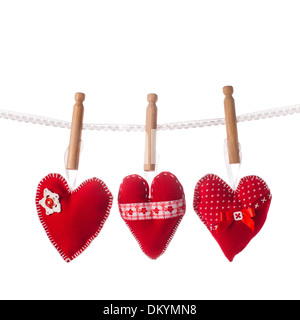 Sewed handmade red hearts on lace isolated Stock Photo