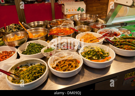 Korean signature Kimchi Stew in a hot ceramic pot served with other side  dishes Stock Photo - Alamy