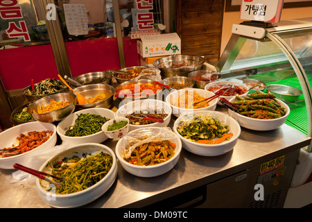 Kimchi and other Korean side dishes displayed for sale at traditional market - Seoul, South Korea Stock Photo