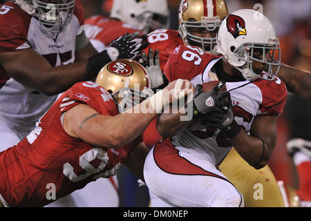 Dec. 14, 2009 - San Francisco, California, U.S - 14 December 2009: Arizona Cardinals running back LaRod Stephens-Howling (36) drags San Francisco 49ers defensive end Justin Smith (94) for a few extra yards during the NFL football game between the Arizona Cardinals and San Francisco 49ers at Candlestick Park in San Francisco, California.    The 49ers won 24-9, keeping their dim play Stock Photo