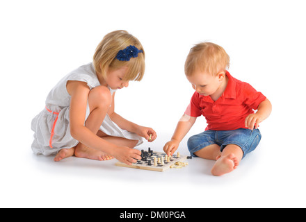 Girl and little boy playing chess isolated over white background Stock Photo