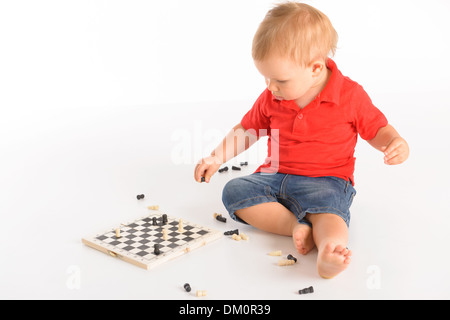 little boy playing chess isolated over white background Stock Photo