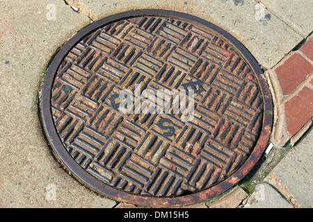 Manhole cover (BSD) in the streets of Boston, Massachusetts, USA Stock Photo