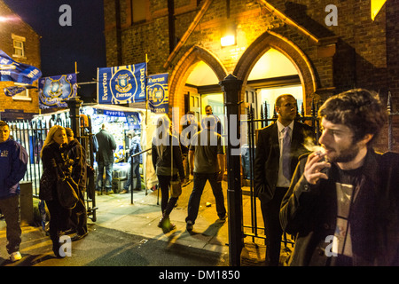 Football fans outside St Lukes Church, Goodison Road, before the midweek game between Everton and Newcastle Utd Stock Photo