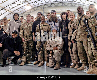 Duck Dynasty reality television star Willie Robertson poses with service members December 10, 2013 at Camp Leatherneck, Afghanistan. Robertson's visit is part of the annual USO holiday tour to help boost the moral of service members deployed overseas. Stock Photo