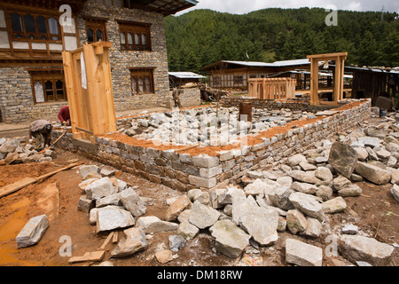 Bhutan, Bumthang Valley, Jakar, Chamkhar town, men building traditional stone house Stock Photo