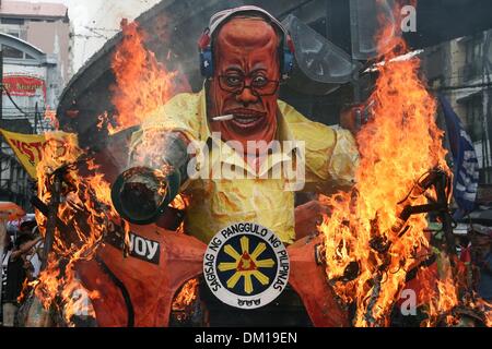 Manila, Philippines. 10th Dec, 2013. President Aquino III's effigy being burned in Mendiola, Manila. -- Protesters commemorated the International Human Rights Day with a march to Mendiola, Manila bringing effigies of President Aquino III. They dubbed Aquino as the ''impunity king'' for alleged human rights violations since he started his term.Photo: J Gerard Seguia/NurPhoto Credit:  J Gerard Seguia/NurPhoto/ZUMAPRESS.com/Alamy Live News Stock Photo