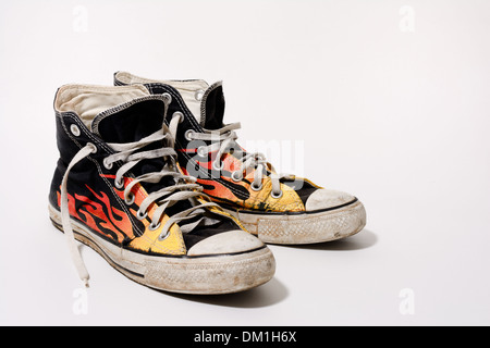 Worn and dirty Converse All Star shoes isolated on white background Stock Photo