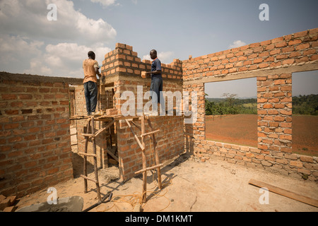 Construction workers build a new warehouse on the outskirts of Kampala, Uganda, East Africa. Stock Photo