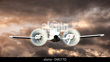 Cessna Axtec flying through the clouds depiction Stock Photo