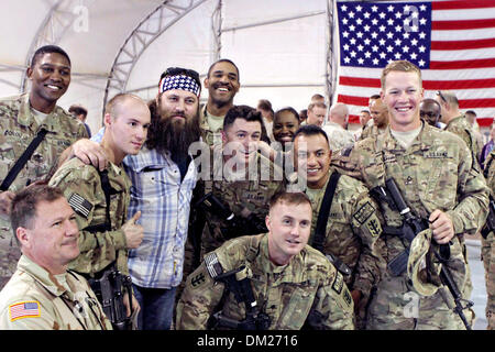 Duck Dynasty reality television star Willie Robertson poses for photos with Marines December 10, 2013 at Camp Leatherneck, Afghanistan.  Robertson's visit is part of the annual USO holiday tour to help boost the moral of service members deployed overseas. Stock Photo