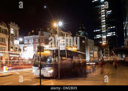 Bus and people at night in London Stock Photo