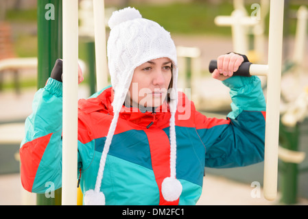 Young woman doing outdoor exercises in a park Stock Photo