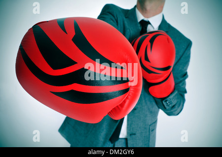 man wearing a suit with boxing gloves throwing a punch Stock Photo