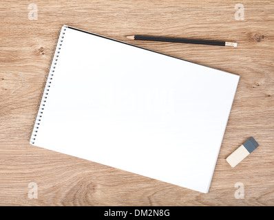 Blank notepad, pencil and eraser on the wooden table. View from above Stock Photo