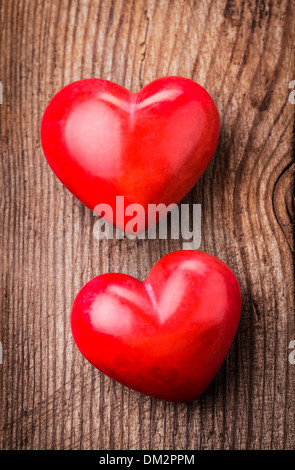 Two red hearts on old shabby wooden background Stock Photo