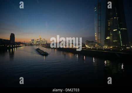 Frankfurt Main, Germany. 10th Dec, 2013. The skyline and the new headquarters of the European Central Bank (R) are seen at sunset as a ship sails up the Main River in Frankfurt Main, Germany, 10 December 2013. Photo: Arne Dedert/dpa/Alamy Live News Stock Photo