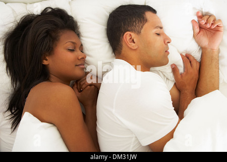 Couple Sleeping In Bed Together Stock Photo
