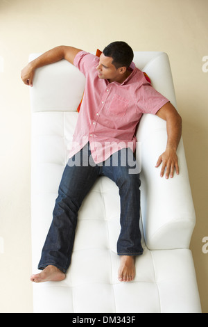 Overhead View Of Man Relaxing On Sofa Stock Photo