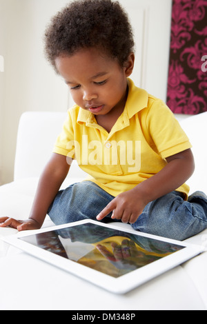 Happy Boy On Sofa Playing With Digital Tablet Stock Photo