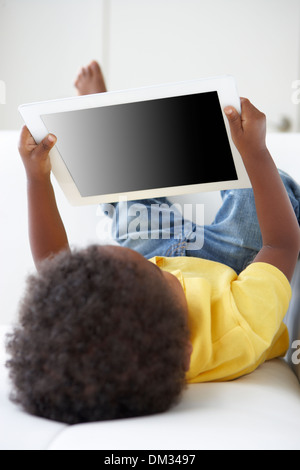 Happy Boy On Sofa Playing With Digital Tablet Stock Photo