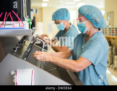 Scrubbing Hands and Arms Before Surgery Stock Photo