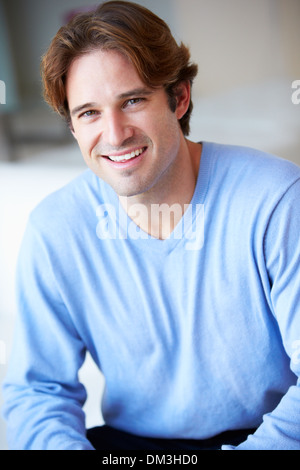 Smiling Man Sitting On Sofa Stock Photo
