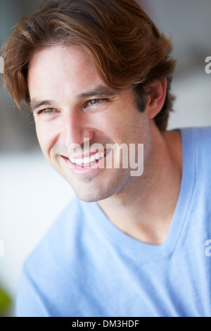 Smiling Man Sitting On Sofa Stock Photo