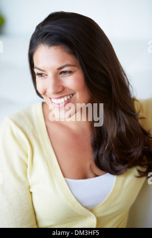 Smiling Woman Sitting On Sofa Stock Photo