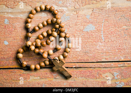 Wooden rosary beads on old wooden table Stock Photo