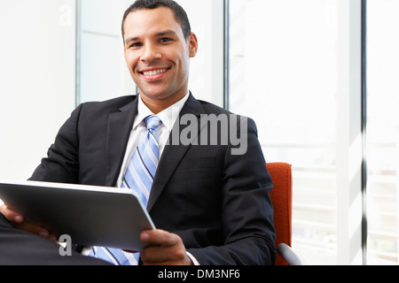Businessman Using Digital Tablet In Office Stock Photo