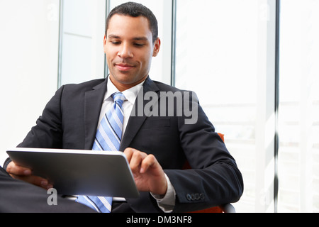 Businessman Using Digital Tablet In Office Stock Photo