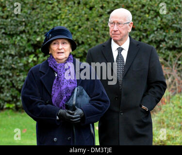 Altrincham, Cheshire, UK. 11th December 2013. Sir Bobby Charlton and his wife, Norma, attend the funeral of Bill Foulkes, who died on November 25th. Bill was one of the Busby Babes, who survived the Munich air crash in February 1958  was captain and played 688 times for Manchester United. Bill Foulkes Funeral  Altrincham  Cheshire  11 December 2013 Credit:  John Fryer/Alamy Live News Stock Photo