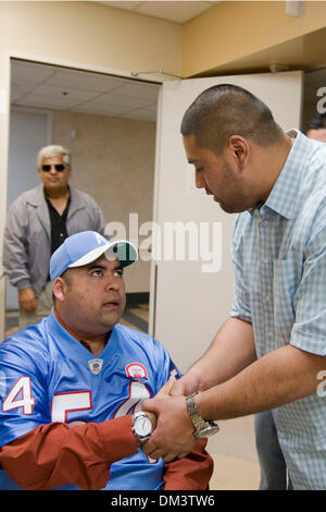 Tennessee Titans offensive lineman Eugene Amano, who grew up in San Diego CA, presented Chris Anguiano with a throwback jersey and a cap at Palomar Hospital where Anguiano receives physical therapy. Anguiano was severly injured in a hatchett attack by a Border Patrol agent, who broke into a home in Escondido CA trying to kill his estranged wife on July 9 2009. Amano, a 2000 graduat Stock Photo