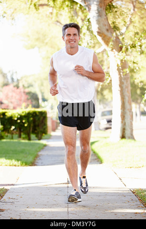 Male Runner Exercising On Suburban Street Stock Photo - Alamy